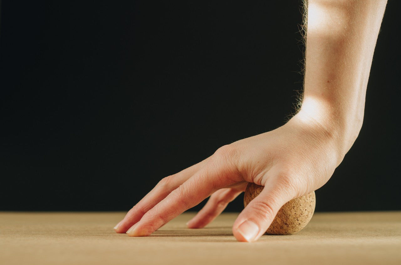 Cork Massage Ball - supporting palm of right hand | TRIBE Yoga