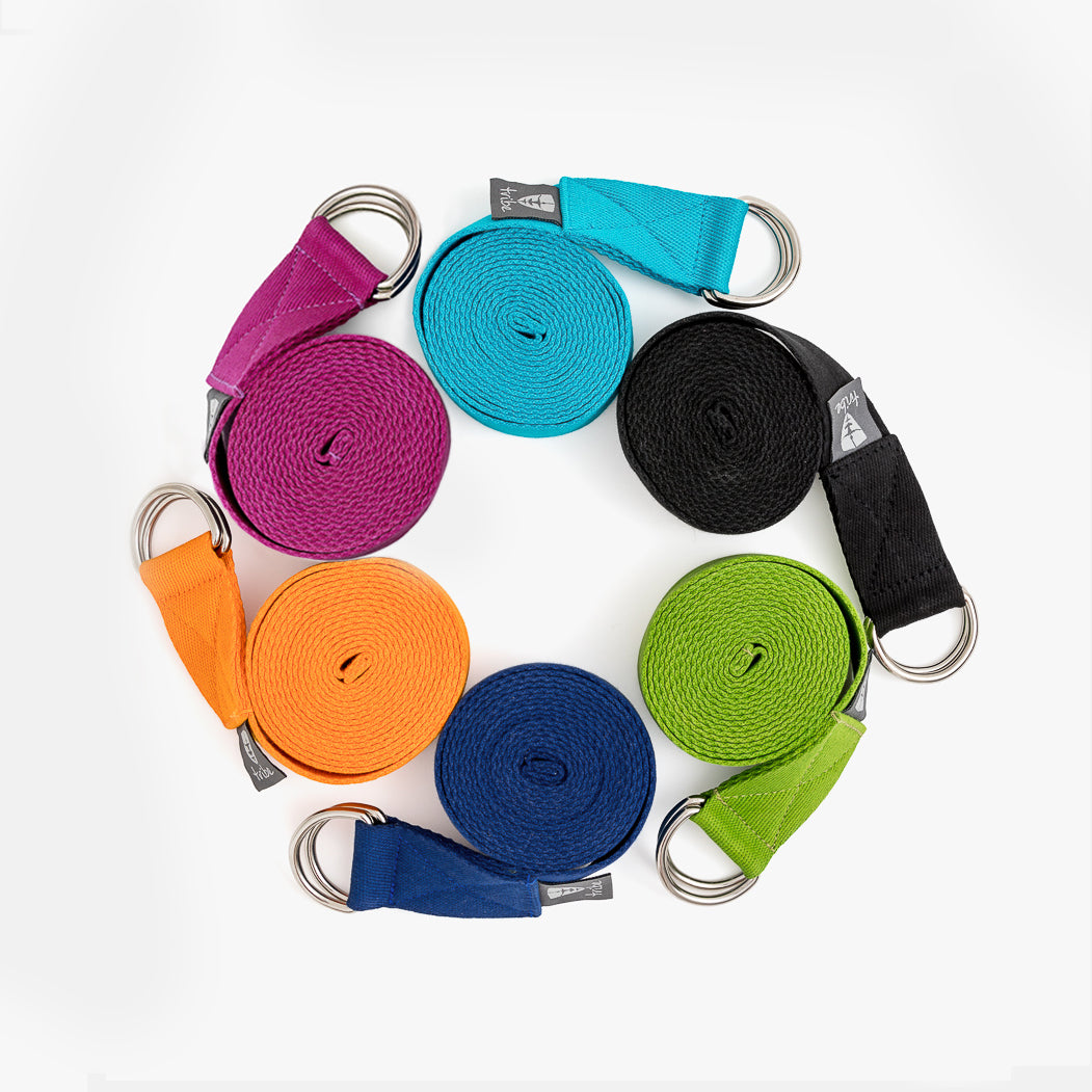 A circle of 6 rolled-up cotton yoga straps | TRIBE Yoga
