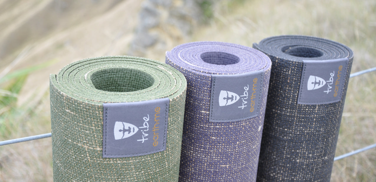 3 Earth Me yoga mats (olive, amethyst, cosmos) against a #8 wire fence n paddock | TRIBE Yoga